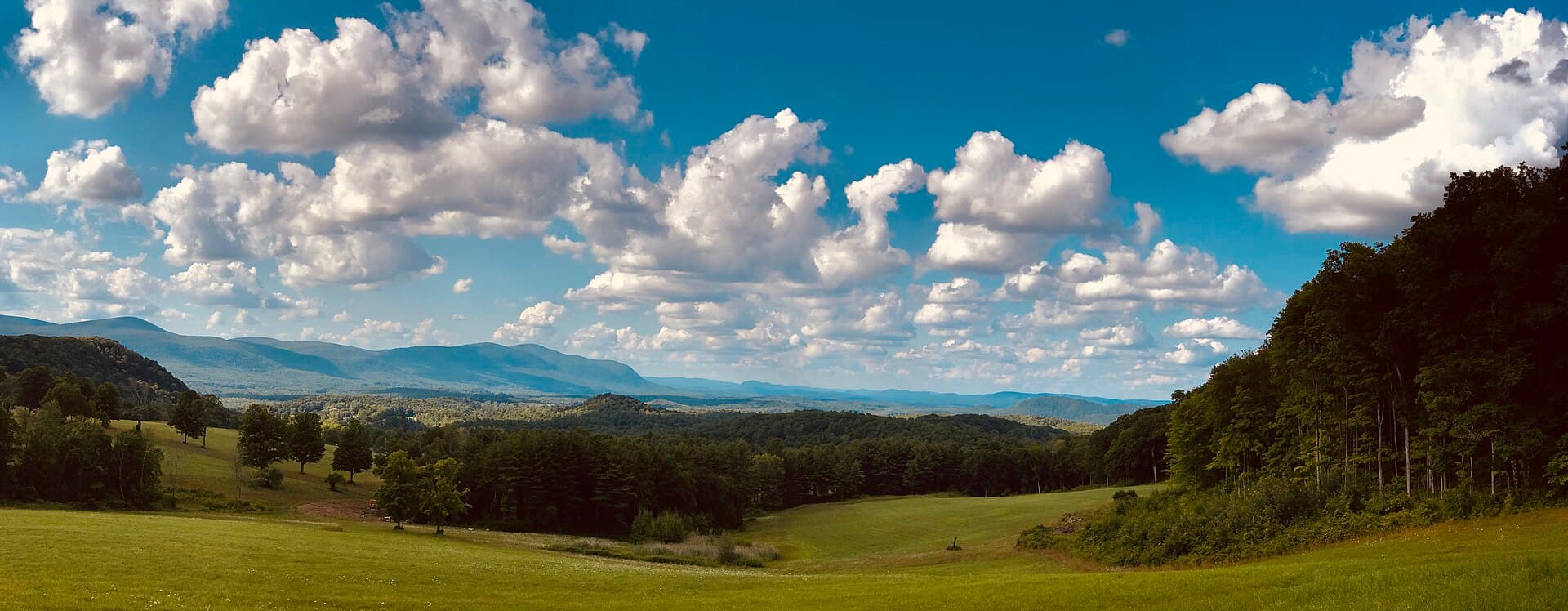 Rolling fields and distant hills under scattered clouds at Rand's View, Salisbury